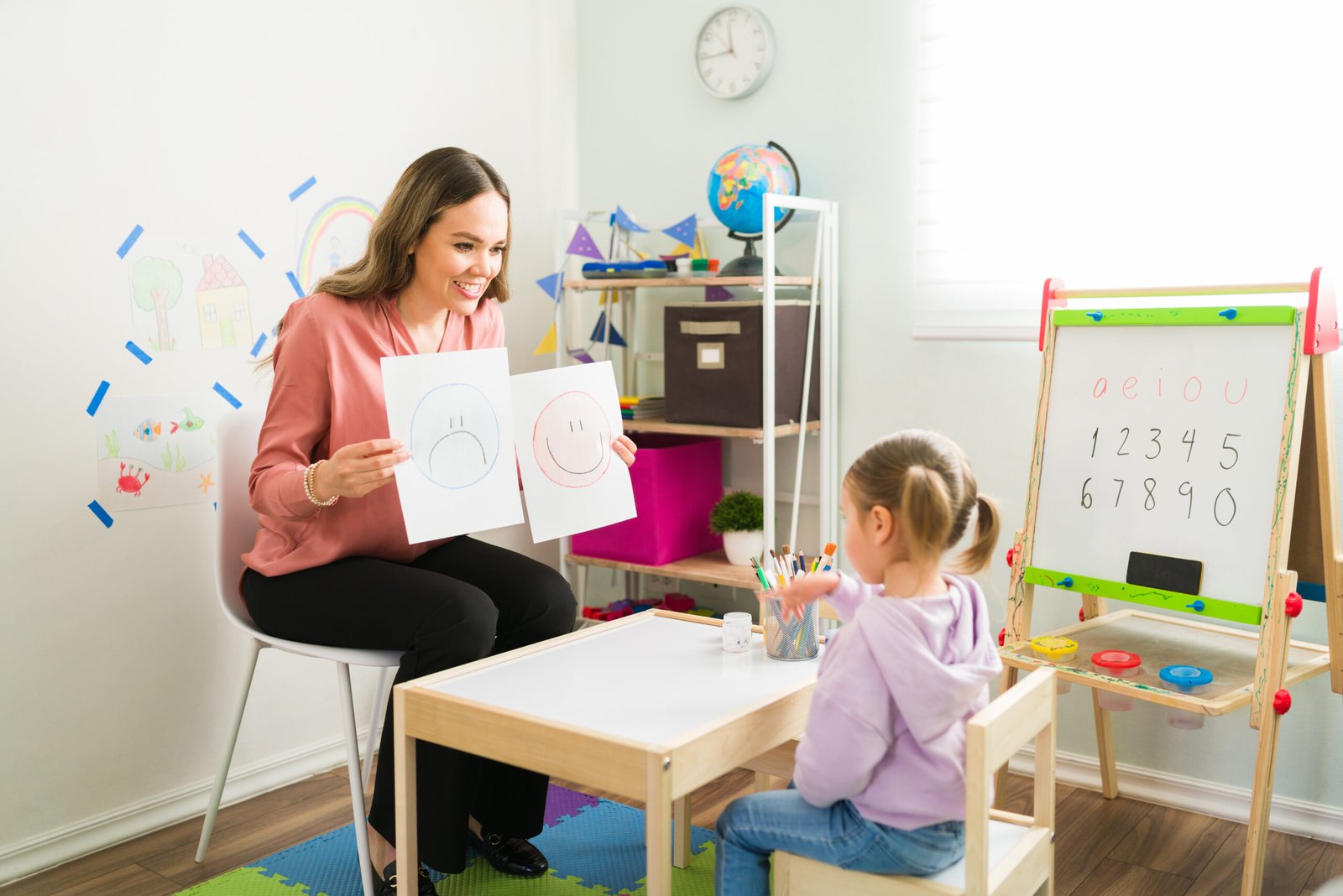 Caucasian therapist talking with a preschooler about her emotions